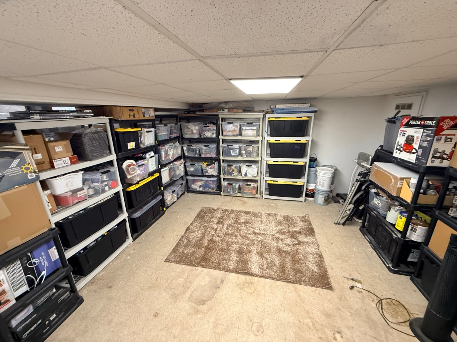 Storage unit after: organized with matching bins, labeled and accessible