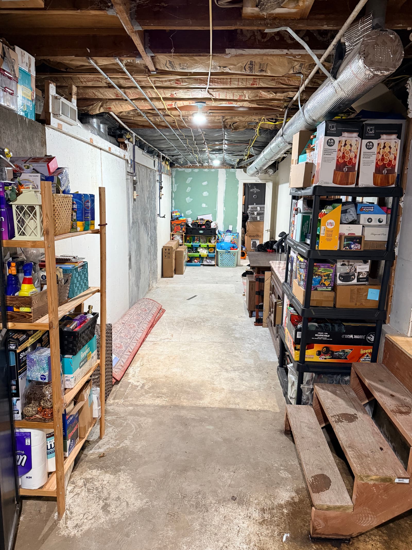 Basement hallway after: walkway completely open, floor visible, space usable again
