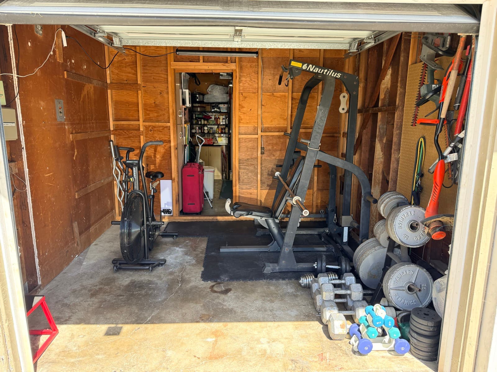 Garage gym after: organized gym with clear zones, equipment accessible