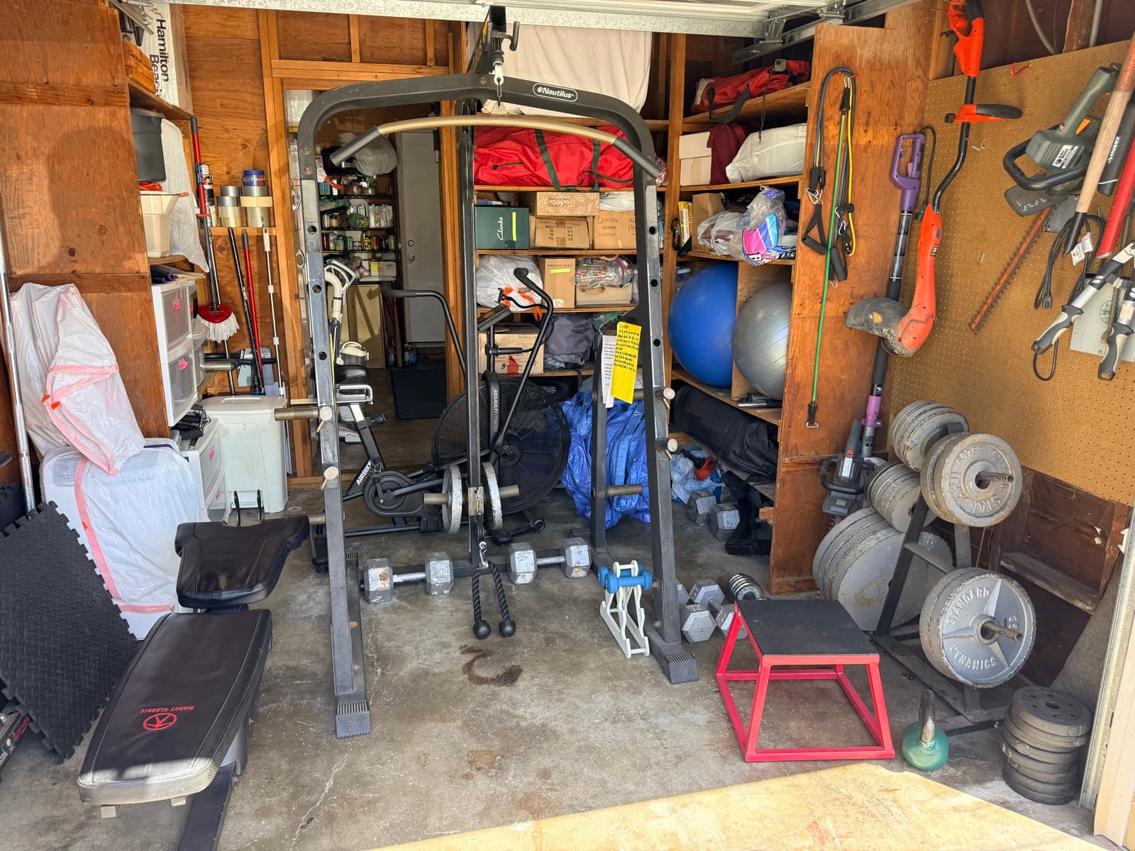 Garage gym before: equipment scattered, no clear layout, hard to use